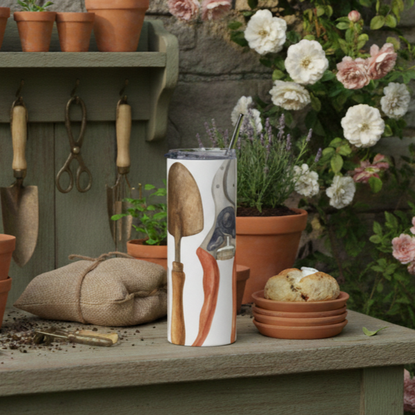 Gardening tools and plants on a wooden table with a stone wall. Flower Farmer's tumbler